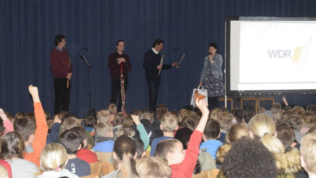In der Elsper Schützenhalle erlebten die Grundschüler ein spannendes WDR-Schulkonzert. Schulleiterin Rebecca Friesekothen (Bühne rechts) begrüßte die Musiker. von Berit Sellmann