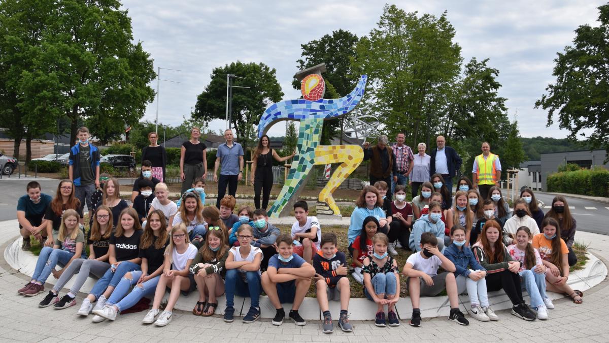 Schüler, Lehrer, Künstler, die Verantwortlichen der Gemeinde und Bürgermeister Achim Henkel strahlen bei der Einweihung der Skulptur um die Wette. von Nicole Voss
