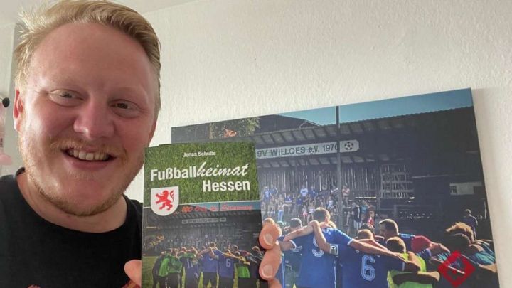 Jonas Schulte mit seinem Buch über hessische Fußballvereine.