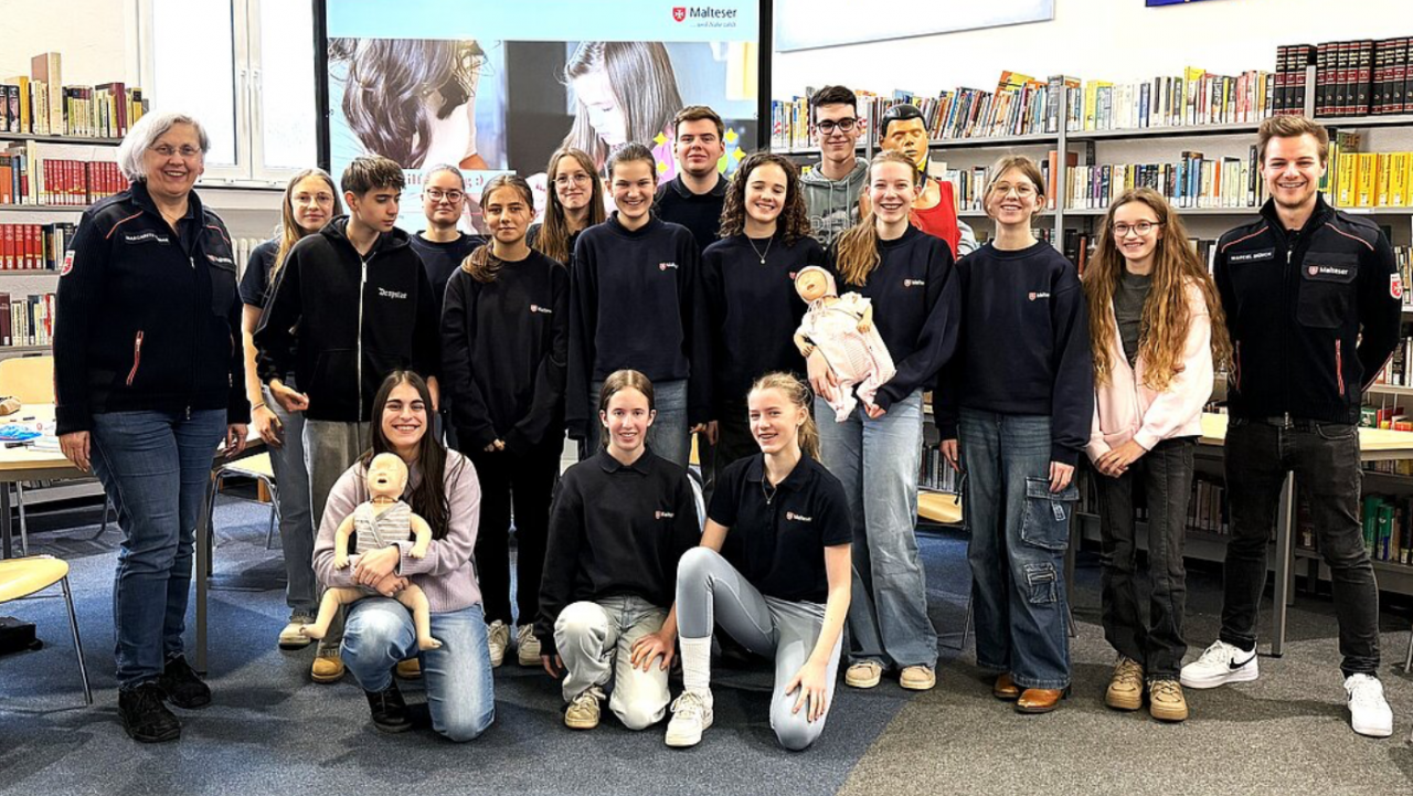 Die 15 Schulsanitäterinnen und Schulsanitäter der St.-Franziskus-Schule mit ihren Ausbildern Margarete Kubiak (l.) und Marcel Münch (r.) nach dem Fortbildungstag in der Schulbibliothek. von privat