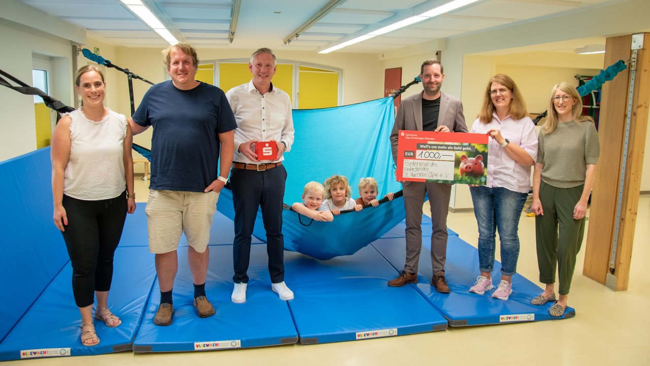 Nino Breitweg (3. v. r) und Björn Scheper (3. v. l.) von der Sparkasse übergaben den symbolischen Scheck an Kindergarten-Leiterin Sabine Schüttler (2. v. r.) und den Vorsitzenden des Fördervereins, Jan Gruß (2. v. l.) im Beisein der Elternbeirats-Mitglieder Christina Burghaus (l.) und Franziska Muckenhaupt (r.). von Sparkasse ODW