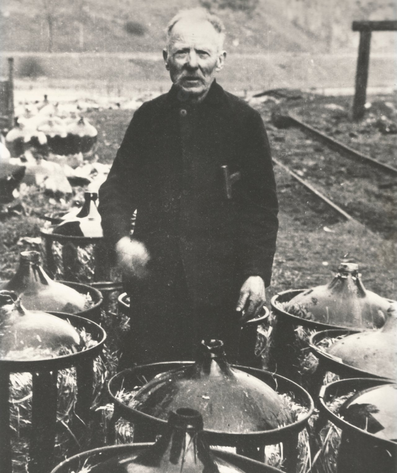 Eine historische Fotografie, die den „Moselpeter“ bei seiner Arbeit zeigt: dem Reinigen großer Glasballons für den Säuretransport. von privat