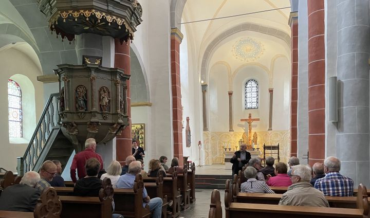 Monsignore Schröder erläutert den Mitgliedern des Kreisheimatbundes Olpe die Renovierungen im alten Teil der Drolshagener St.-Clemens-Kirche.