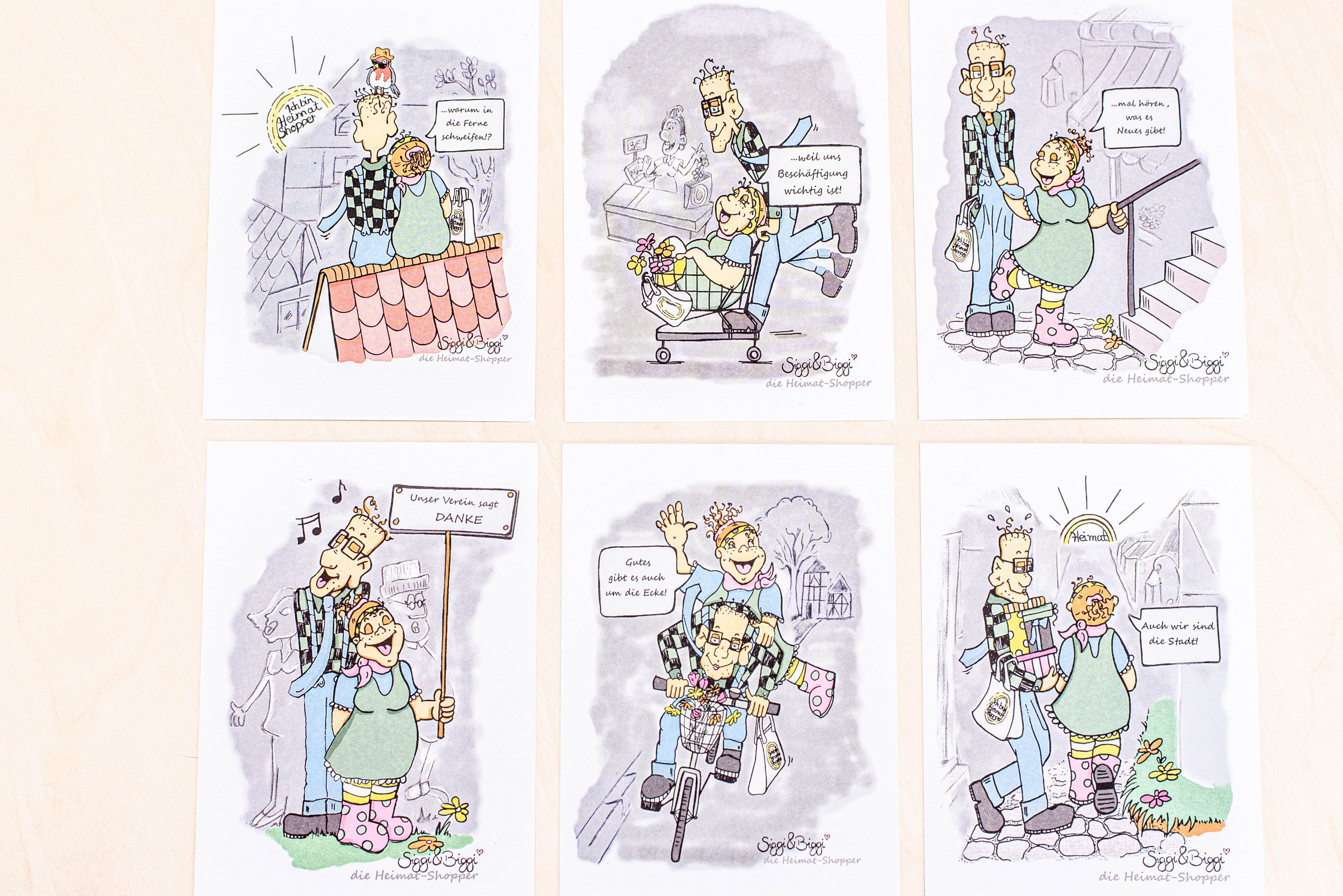 Statt Flyern zum Heimat shoppen gibt es sechs Postkarten mit den Comicfiguren Biggi und Siggi. von Nils Dinkel