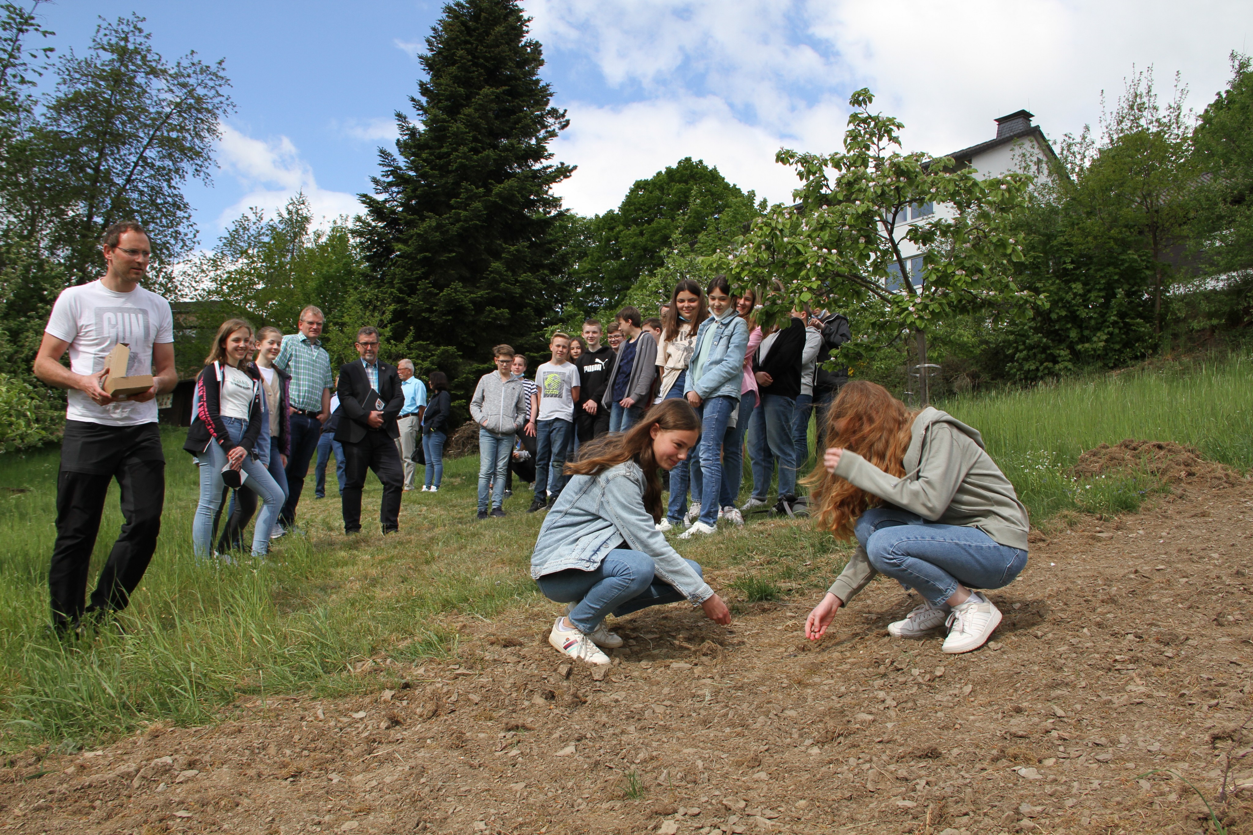 Adriana Ottmann (l.) und Greta Bankstahl streuen erste Samen einer Saatmischung mit heimischen Pflanzen aus. von Kerstin Sauer
